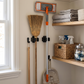 Wall-Mounted Stainless Steel Broom & Mop Holder in a practical small-space lifestyle setting