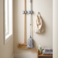 Self-Adhesive Wall-Mounted Broom & Mop Holder in a practical small-space lifestyle setting