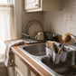 Plastic Saddle Sink Caddy for Brushes & Sponges in a practical small-space lifestyle setting