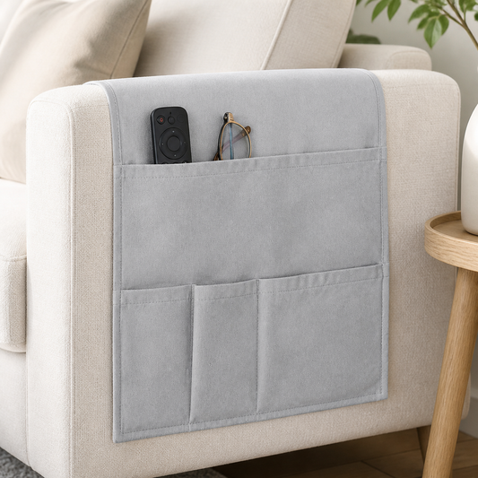 Gray water-resistant sofa arm organizer with remote and glasses in storage pockets